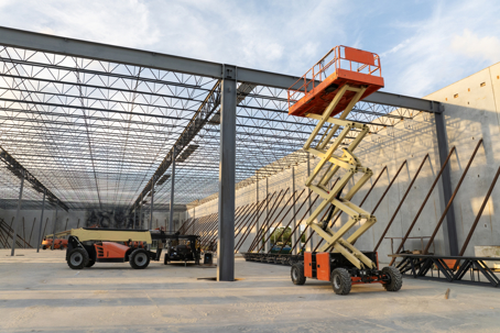 Warehouse construction. Concrete and metal structure of industrial building.
